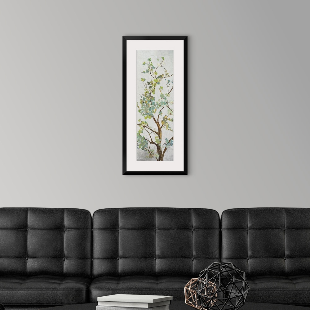 A modern room featuring Tree branch with light green leaves on grey.