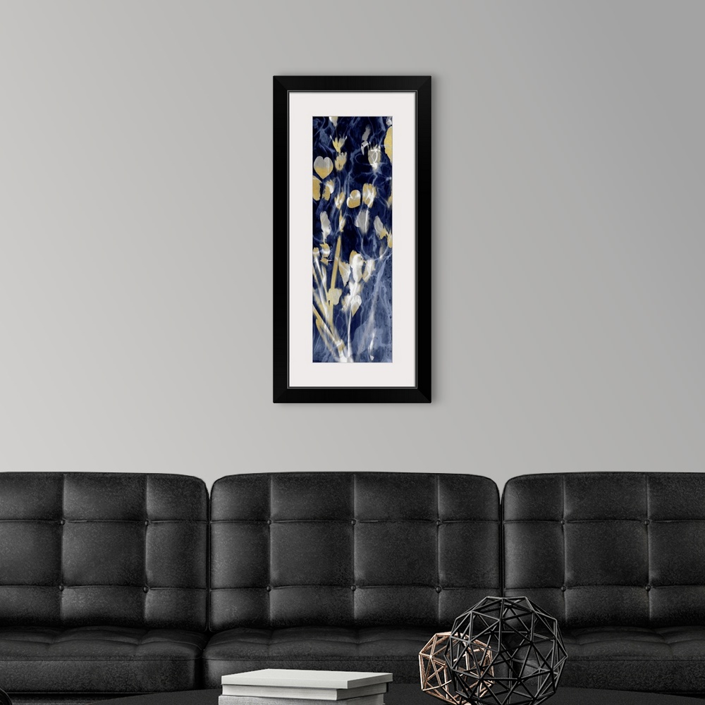 A modern room featuring Paneled artwork with metallic gold silhouetted leaves on an hazy indigo background.