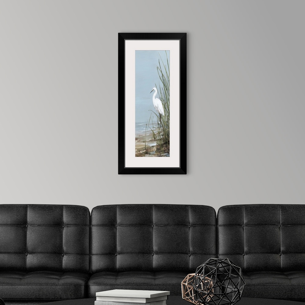 A modern room featuring Tall panel painting of an egret walking on the shore with tall beach grass.