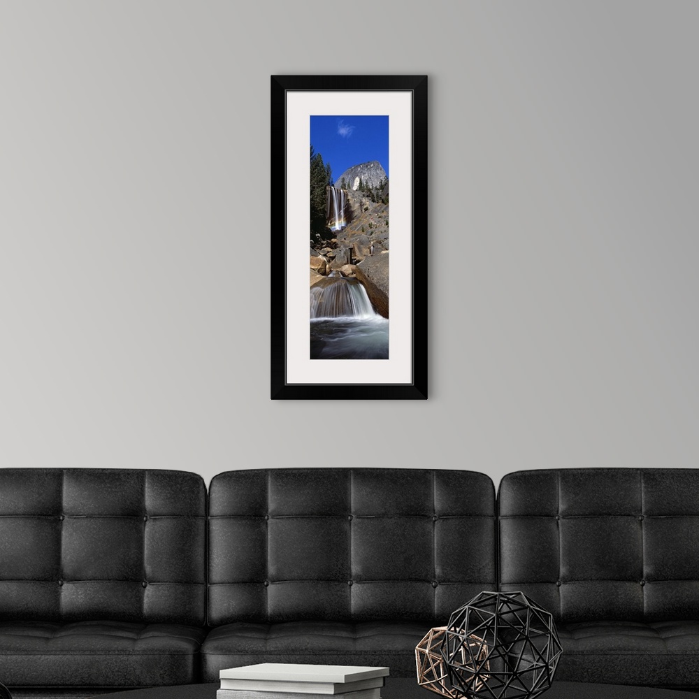 A modern room featuring This picture is taken from below and looking up toward the top of a waterfall that flows over lar...