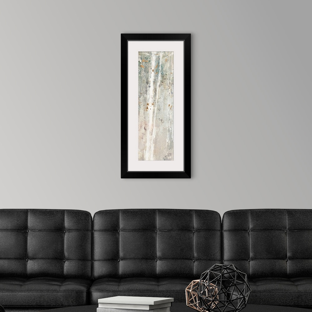 A modern room featuring Decorative artwork of a white slender trees with fluttering brown leaves over a subdued gradated ...