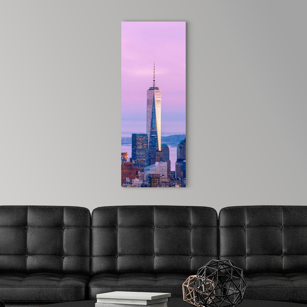 A modern room featuring Illuminated One World Trade Center amidst buildings against sky in city at dusk, Manhattan, New Y...
