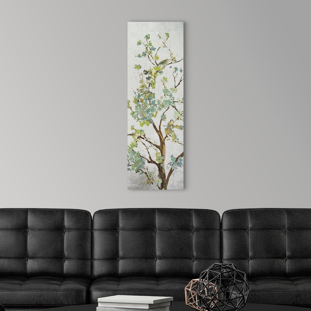 A modern room featuring Tree branch with light green leaves on grey.