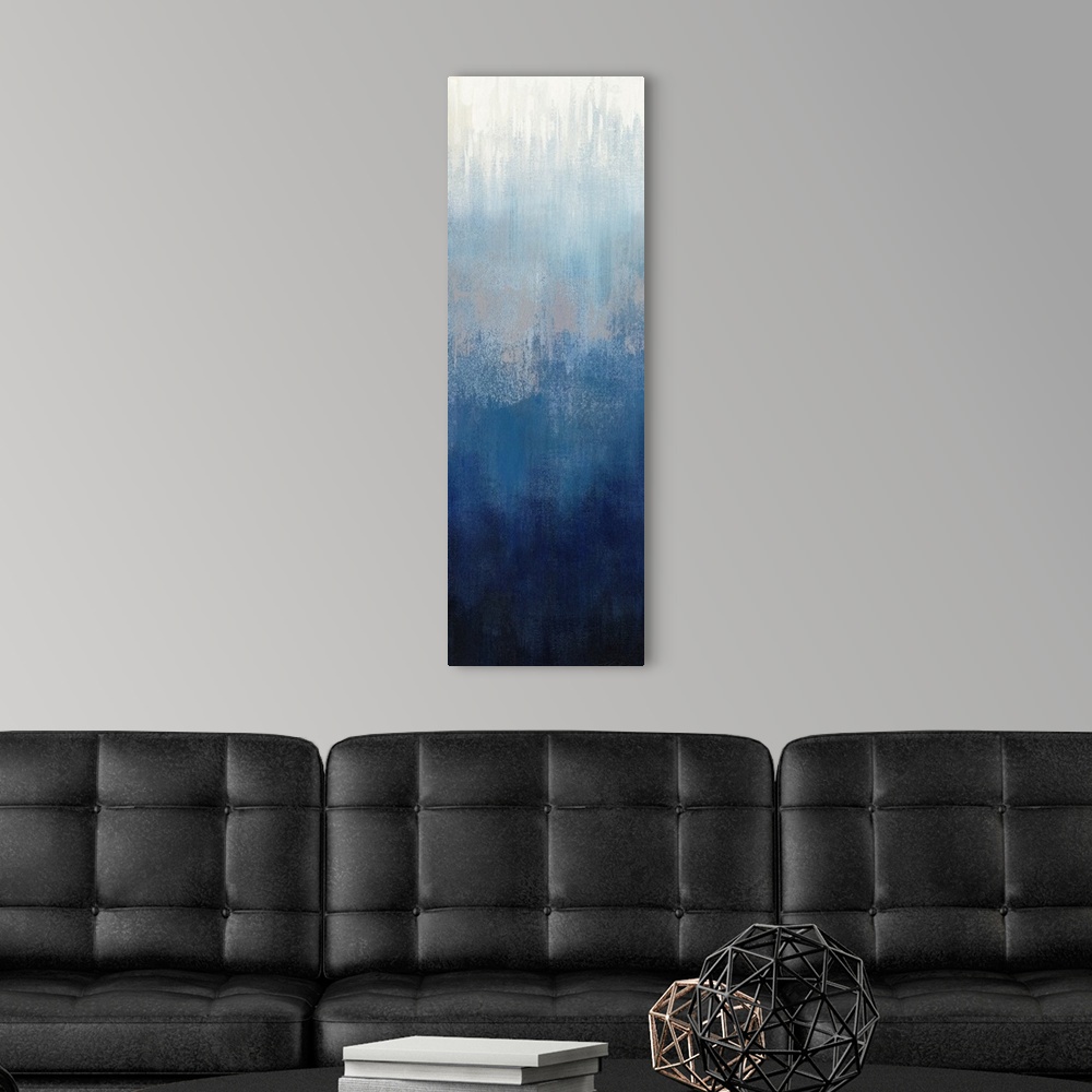 A modern room featuring Abstract panel painting in shades of gray and blue getting darker towards the bottom.