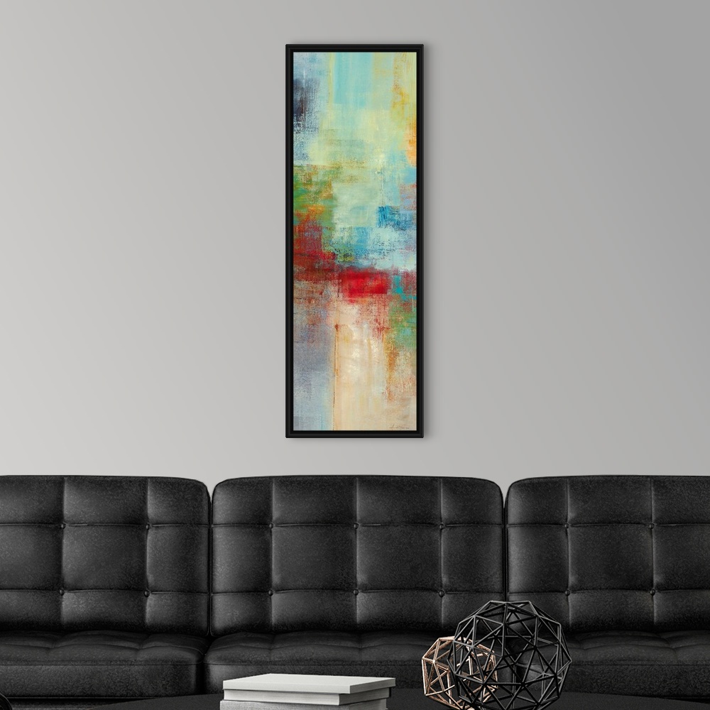 A modern room featuring A narrow piece of abstract artwork that is filled with mostly cool blocks of colors and a pop of ...