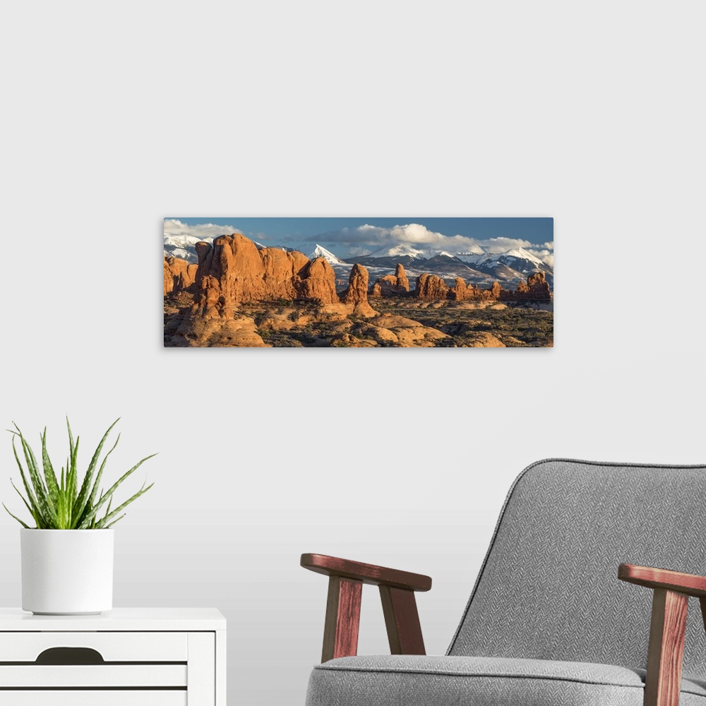 A modern room featuring North America, USA, Utah.  Red rock formations of the Windows Section with clouds and snow on the...