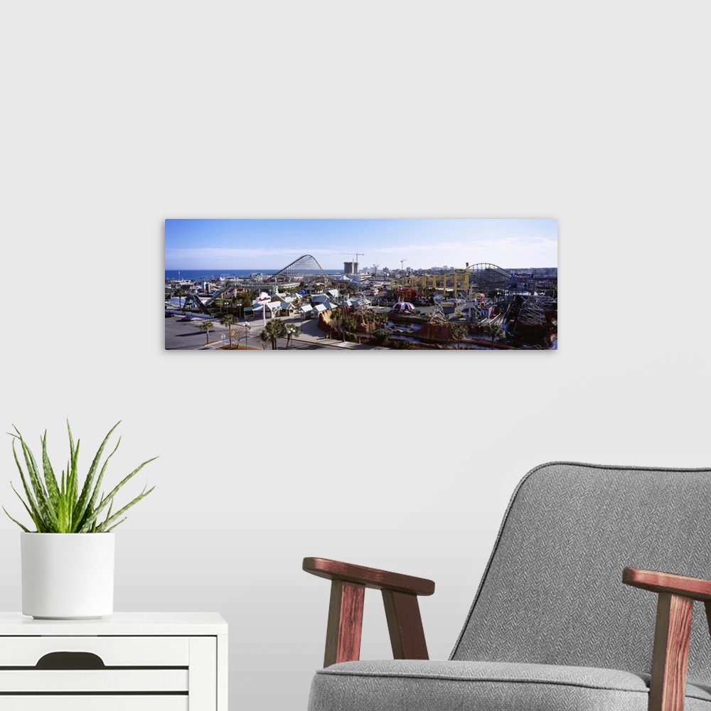 A modern room featuring Oversized, aerial landscape photograph of  an amusement park with several roller coasters, beneat...