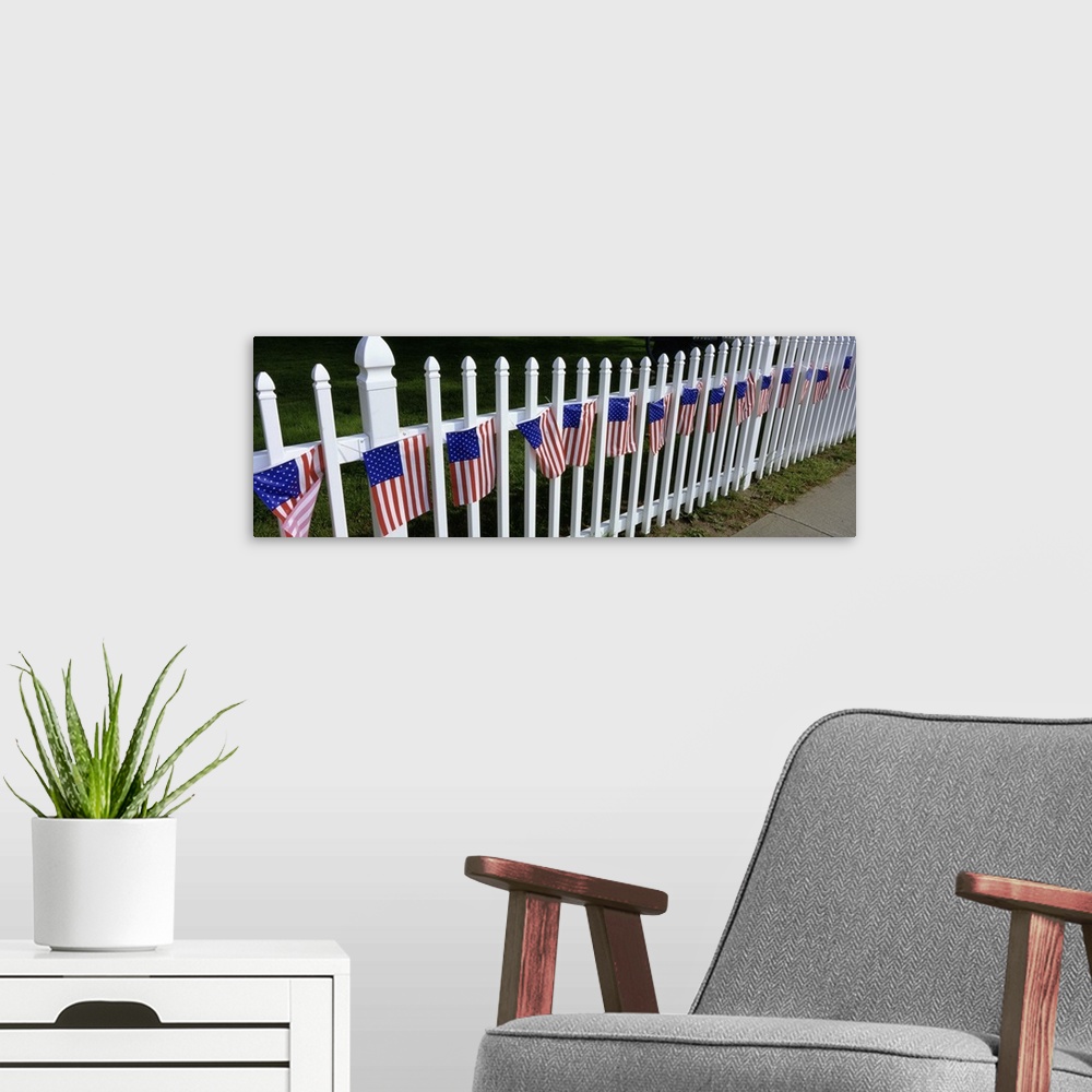 A modern room featuring American flags hanging on a picket fence