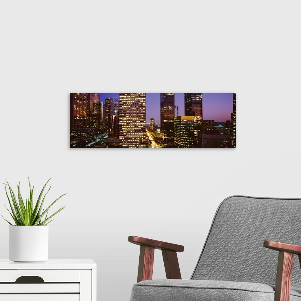 A modern room featuring Panoramic, close up photograph of lit skyscrapers at night, in Los Angeles, California, a vivid s...