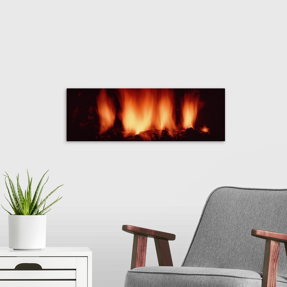 A modern room featuring Close-up of fire in fireplace
