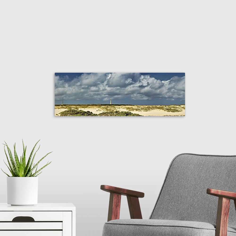 A modern room featuring Clouds over the beach with California Lighthouse in the background, Aruba