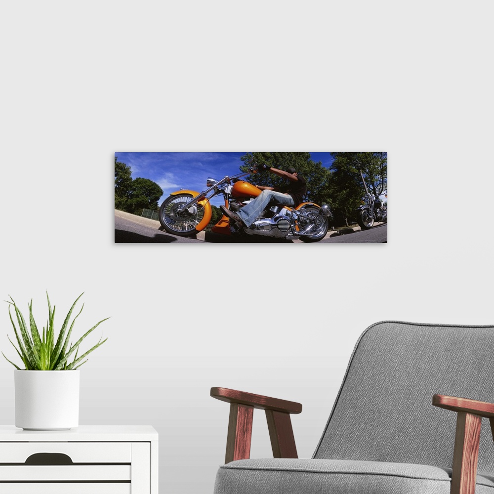 A modern room featuring Low angle view of a man riding a motorcycle, Wisconsin