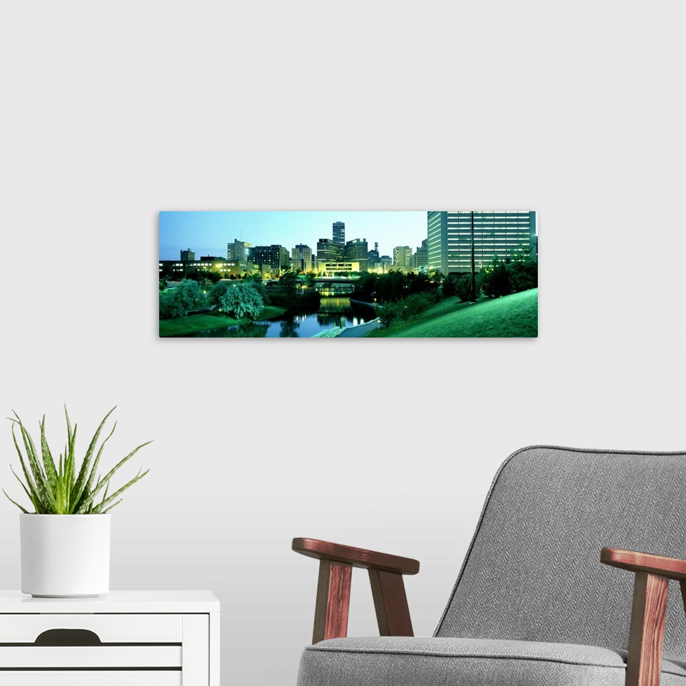 A modern room featuring Photograph taken of the city skyline in Omaha Nebraska during dusk with the buildings lit up and ...