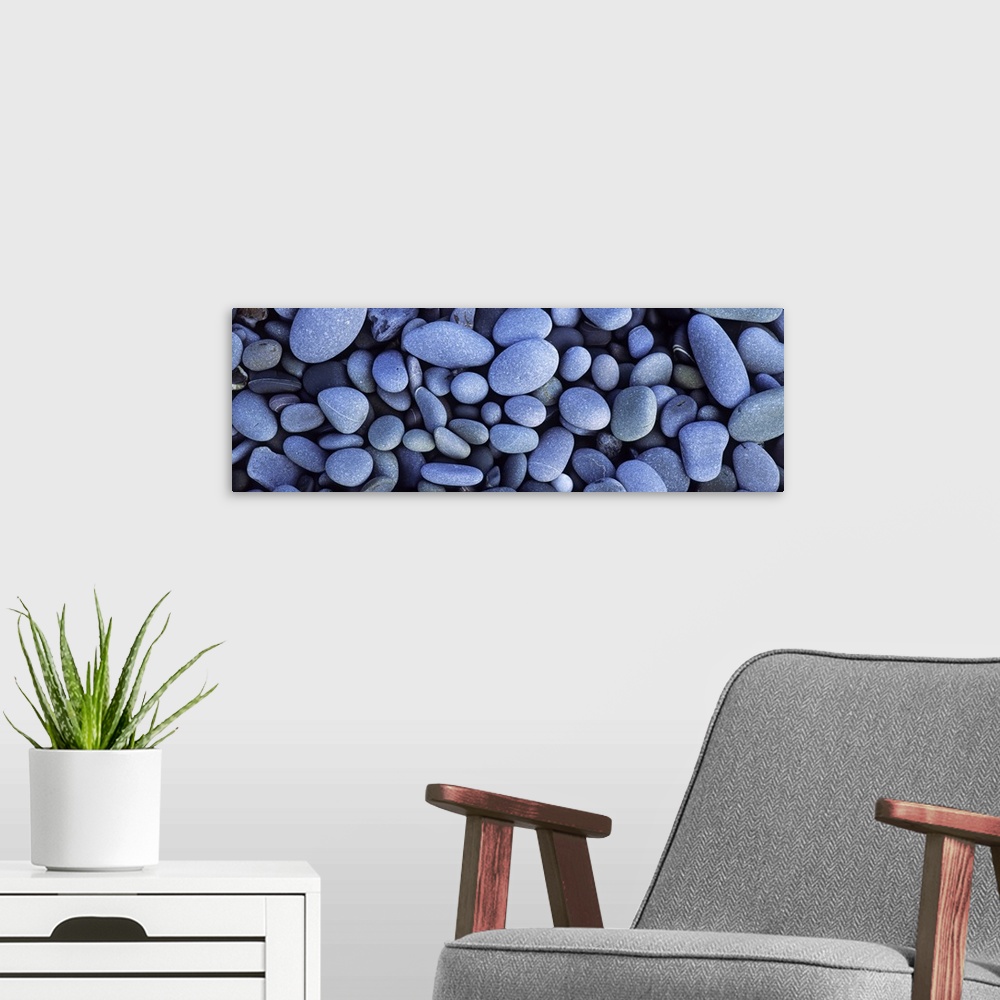 A modern room featuring Close up horizontal photograph of smooth pebbles in various sizes, on Sandymouth Beach in Cornwal...