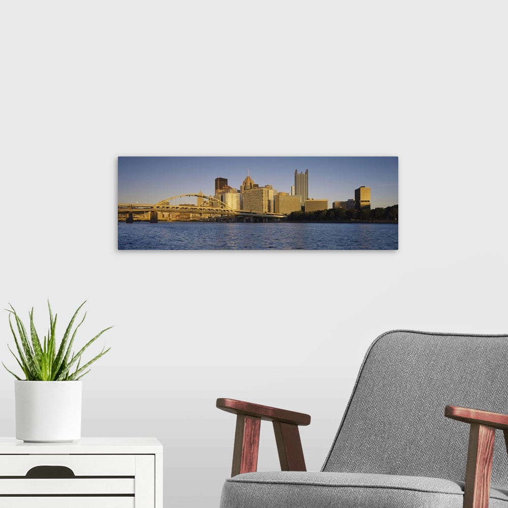 A modern room featuring Giant, panoramic photograph of the Pittsburgh skyline, and the Fort Pitt Bridge in the foreground...