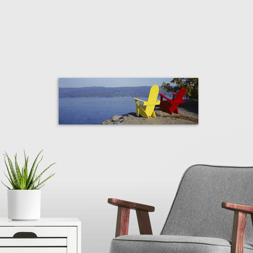 A modern room featuring Red And Yellow Adirondack Chairs Near A Lake, Champlain Lake, Vermont