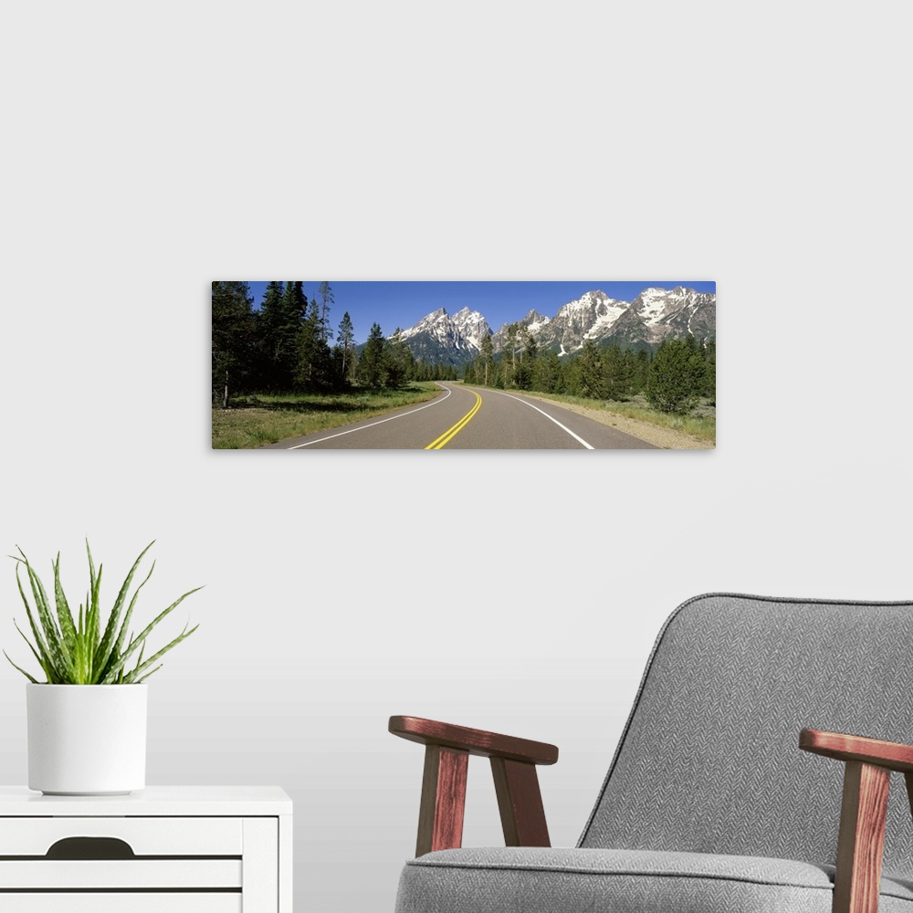 A modern room featuring Road w/ Teton Range in distance Grand Teton National Park WY