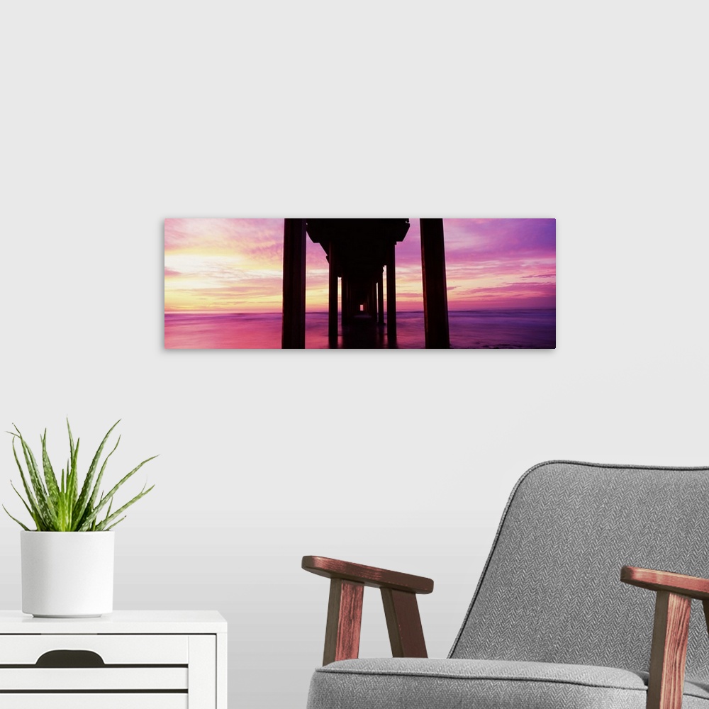 A modern room featuring Silhouette of a pier in the Pacific Ocean at sunset, Scripps Pier, La Jolla, San Diego, Californi...