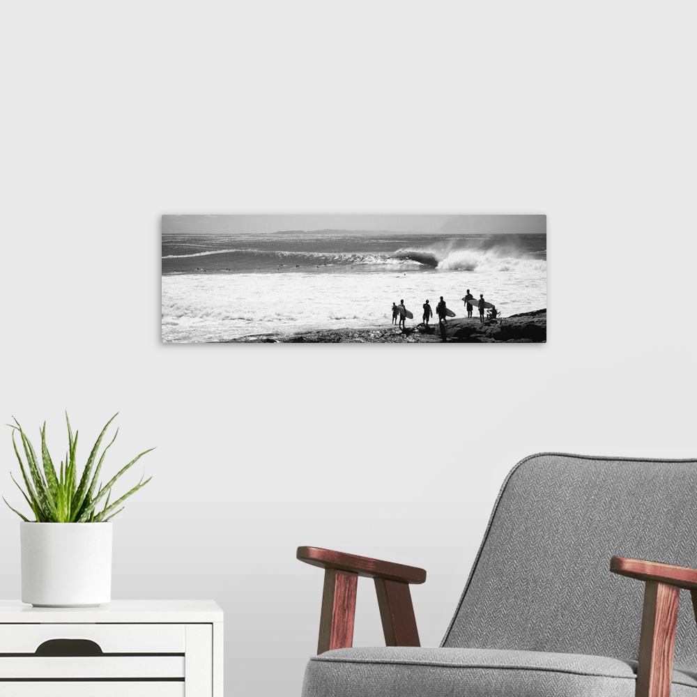 A modern room featuring Silhouette of surfers standing on the beach, Australia