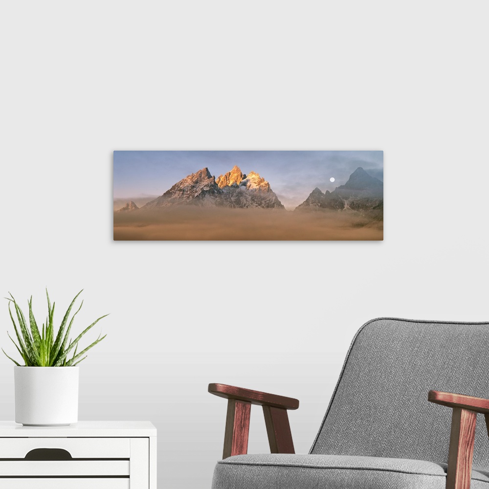 A modern room featuring The Teton peaks catch first light above the valley fog, Grand Teton National Park, Teton County, ...