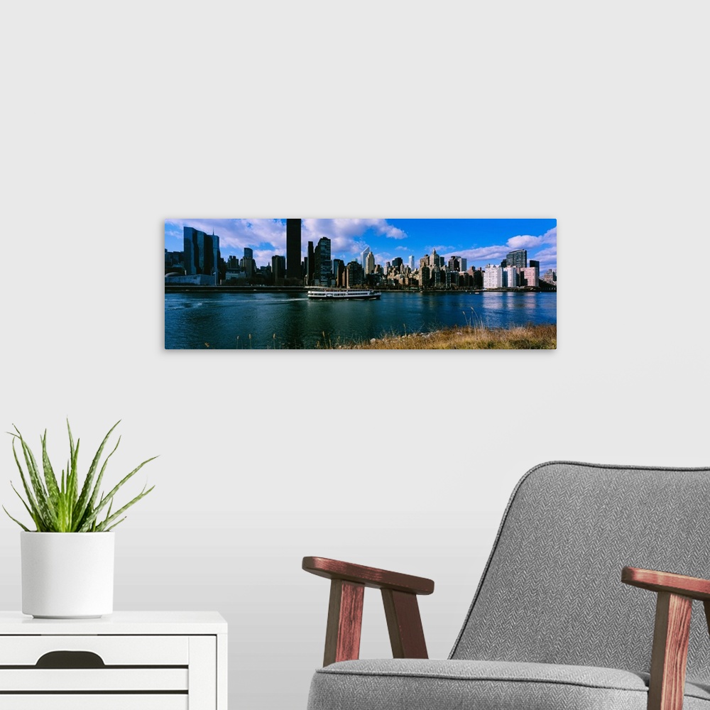 A modern room featuring Tourboat moving in river, East River, Manhattan, New York City, New York State, USA