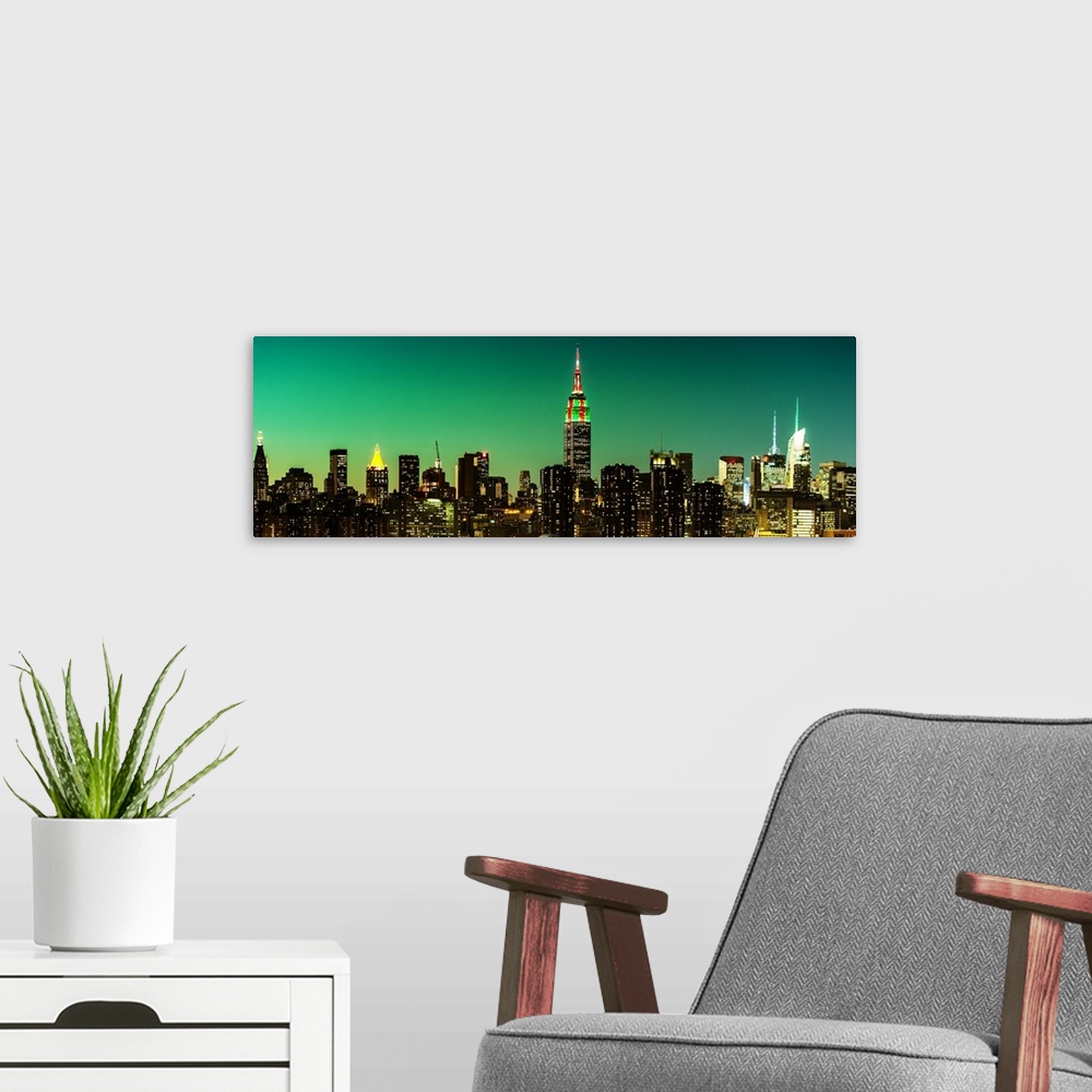A modern room featuring A photograph of the New York city skyline at night, with the Empire state building standing tall.
