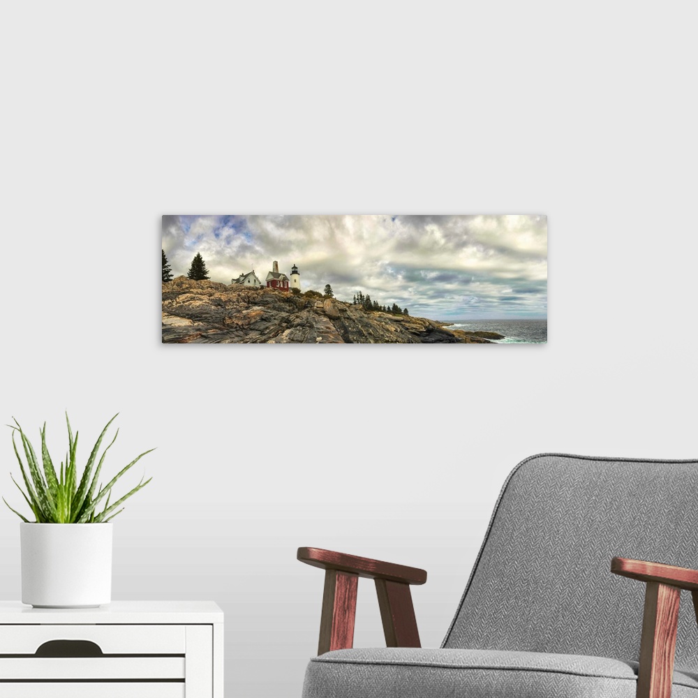 A modern room featuring Panoramic photography of Pemaquid Lighthouse on the rocky coast under stunning clouds.