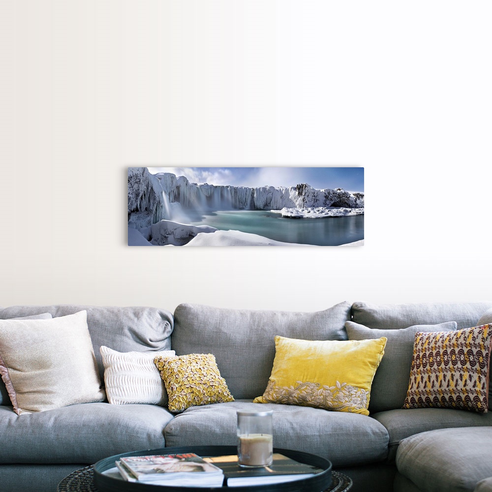 A farmhouse room featuring Icy snow covered landscape with waterfalls streaming down from cliffs surrounding a river.