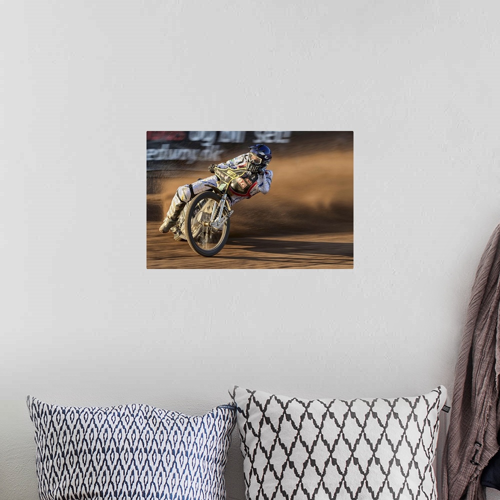 A bohemian room featuring A motocross racer learning into a curve at the Fjelsted Speedway, Denmark.