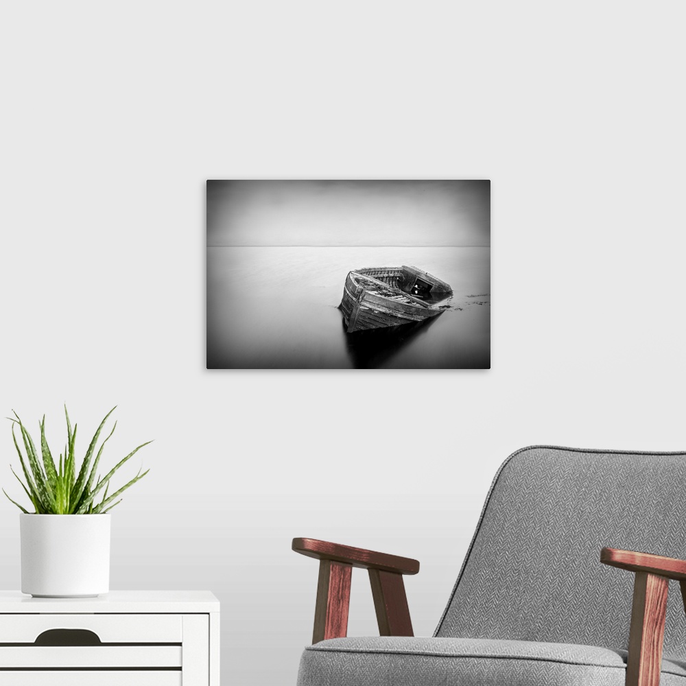 A modern room featuring Long exposure of a abandoned boat in black and white.