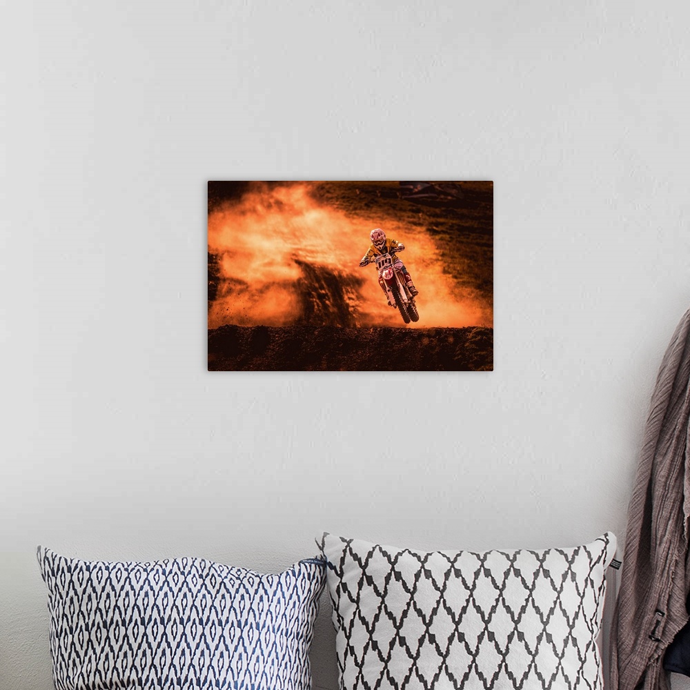 A bohemian room featuring A photograph of a motocross rider caught in the air while riding a dirt track.
