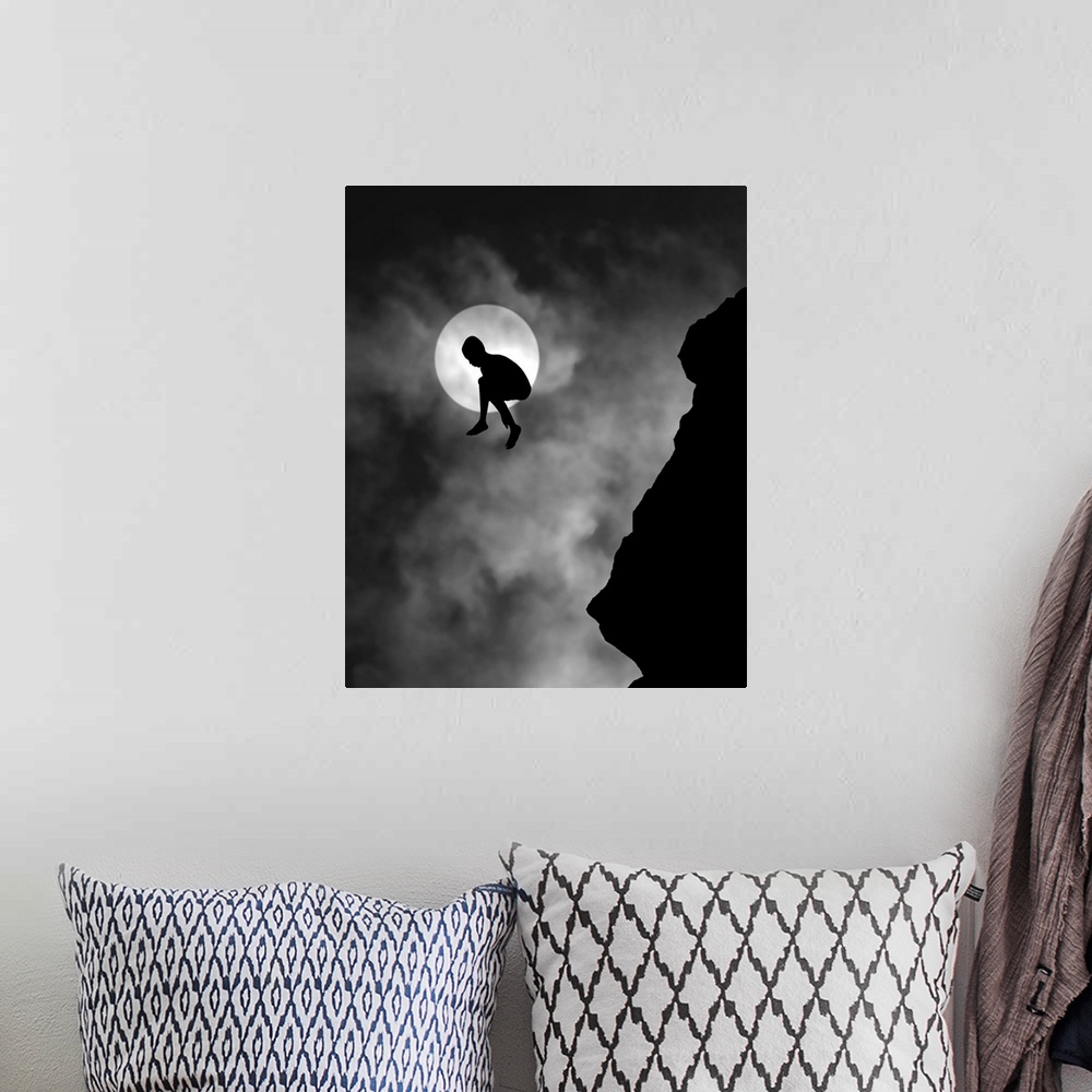 A bohemian room featuring Silhouette of a person jumping off a cliff, with the moon directly behind.