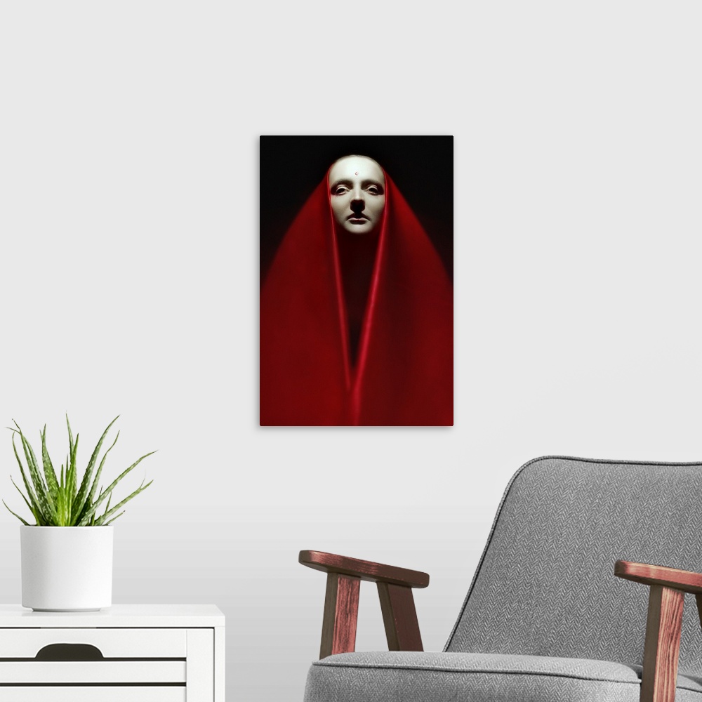A modern room featuring Portrait of a person wearing a long red veil over their head and around their body.