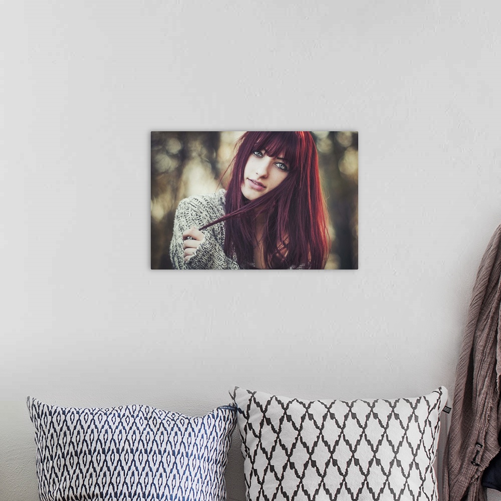 A bohemian room featuring Portrait of a beautiful young woman with dark red hair.