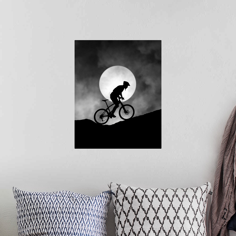 A bohemian room featuring Silhouette of a biker pedaling up a hill, with the moon low in the sky.
