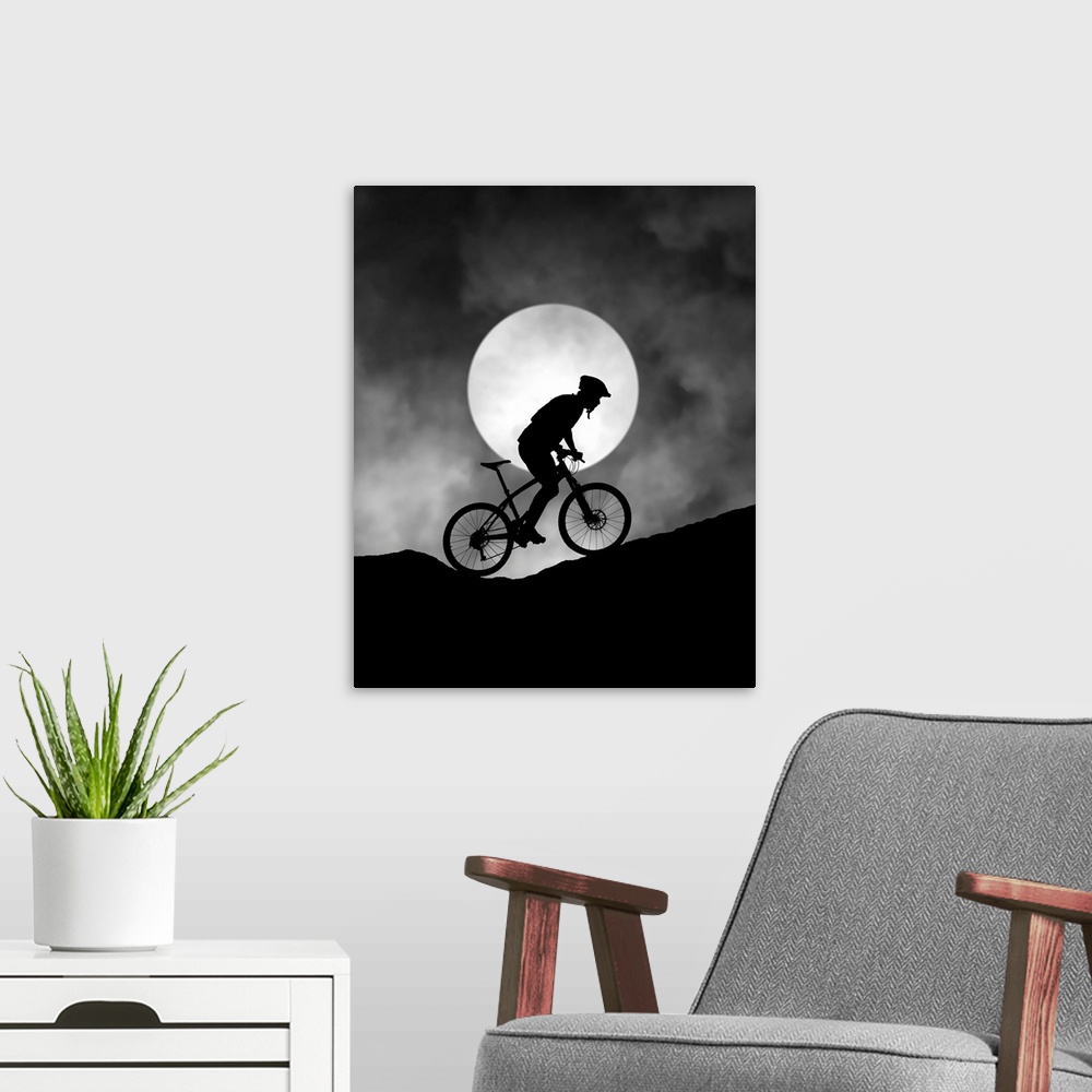A modern room featuring Silhouette of a biker pedaling up a hill, with the moon low in the sky.