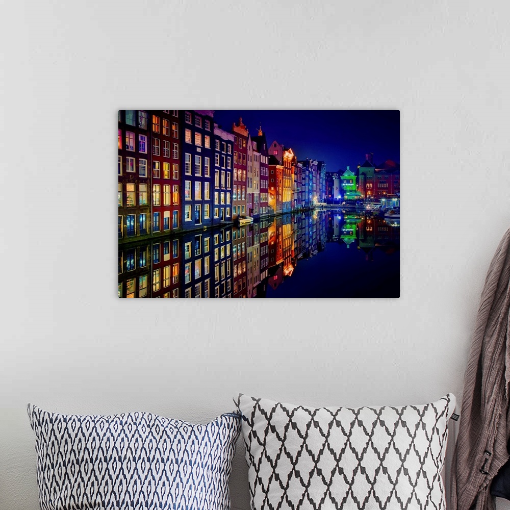 A bohemian room featuring A glowing row of buildings in Amsterdam reflecting in the canal below.