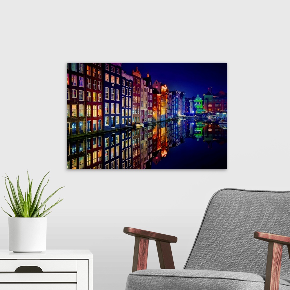 A modern room featuring A glowing row of buildings in Amsterdam reflecting in the canal below.