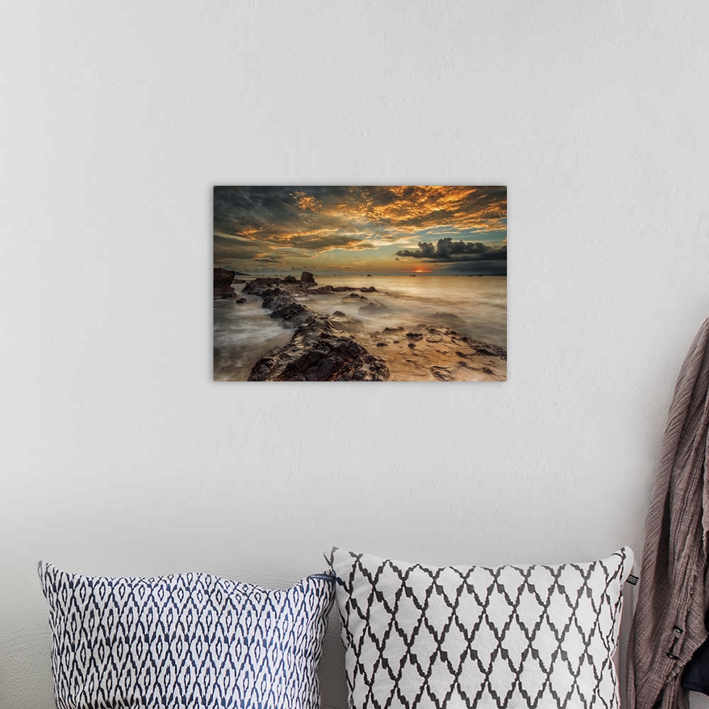 A bohemian room featuring A beach scene under a sky filled with dramatic clouds of sunset.
