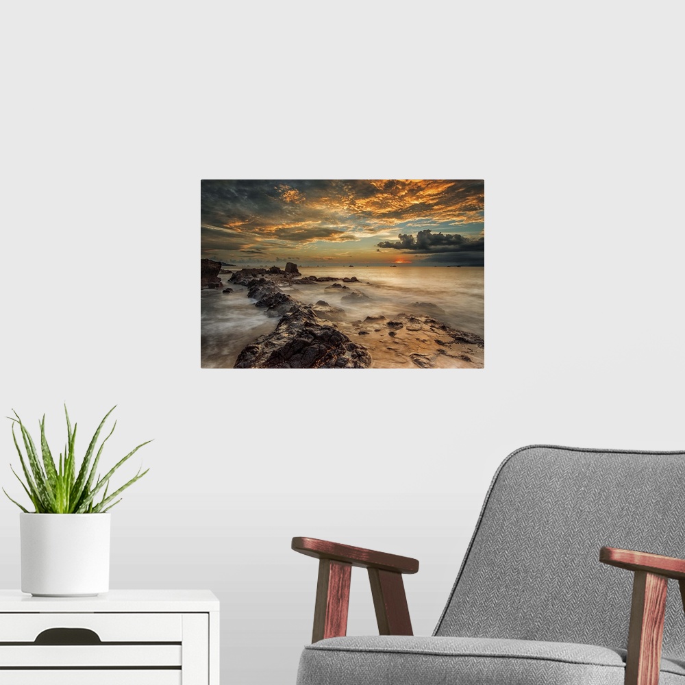 A modern room featuring A beach scene under a sky filled with dramatic clouds of sunset.