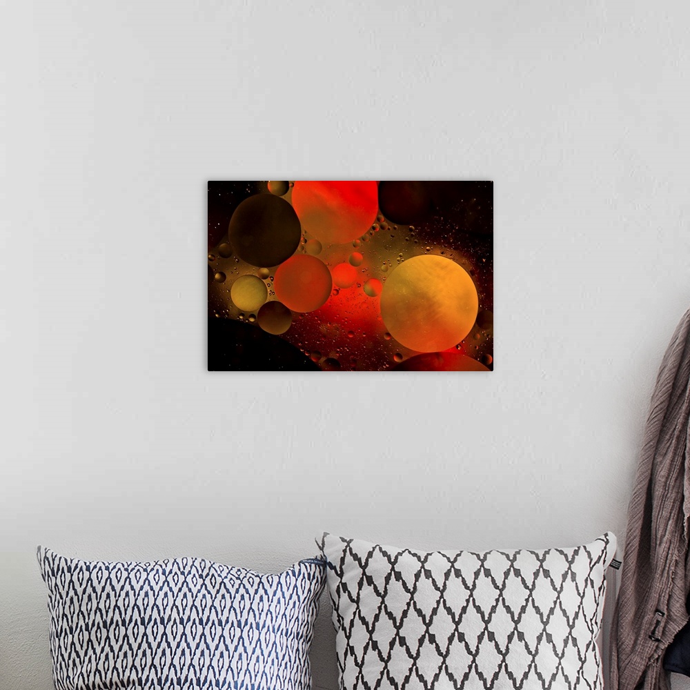 A bohemian room featuring Abstract photograph of a warm red and orange colored water bubbles.