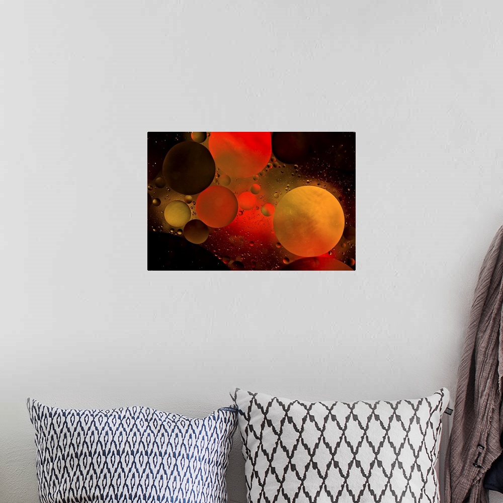 A bohemian room featuring Abstract photograph of a warm red and orange colored water bubbles.
