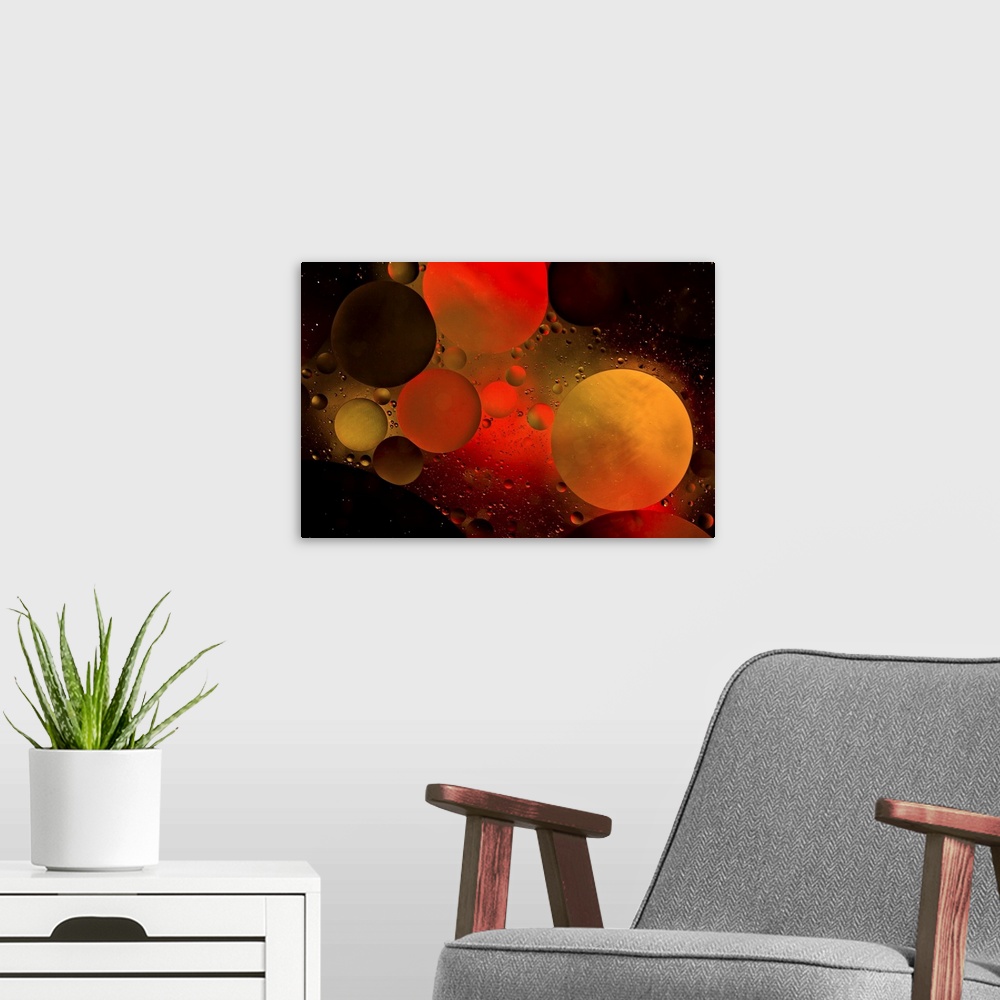 A modern room featuring Abstract photograph of a warm red and orange colored water bubbles.