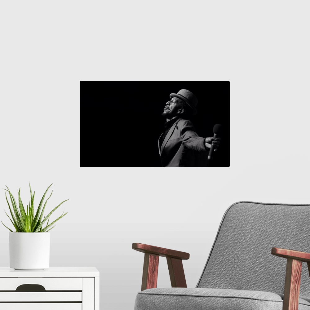 A modern room featuring A black and white portrait of a musician giving a performance.