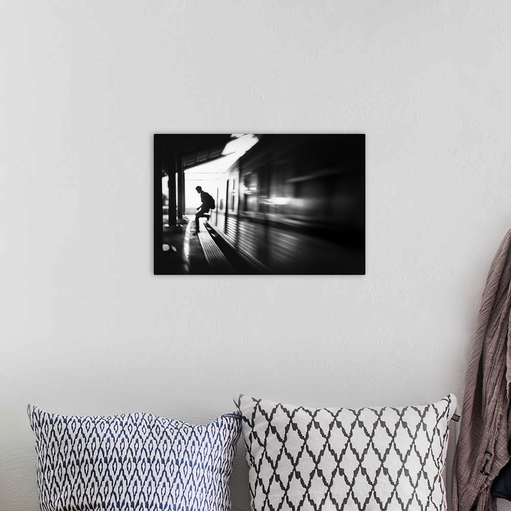 A bohemian room featuring Blurred motion image of a man jumping out of a train at the station in Jakarta.