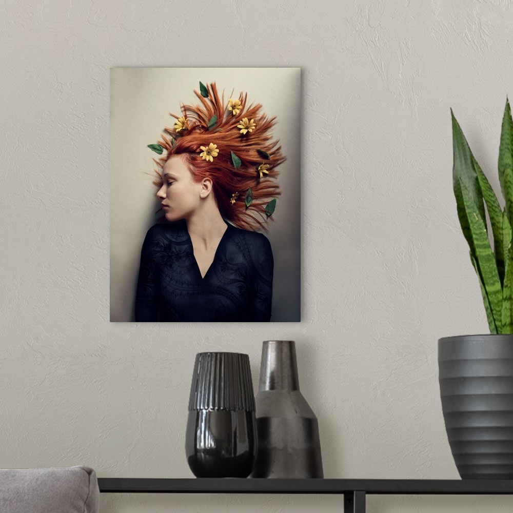A modern room featuring A portrait of a woman laying against a white surface with yellow flowers in her red hair.