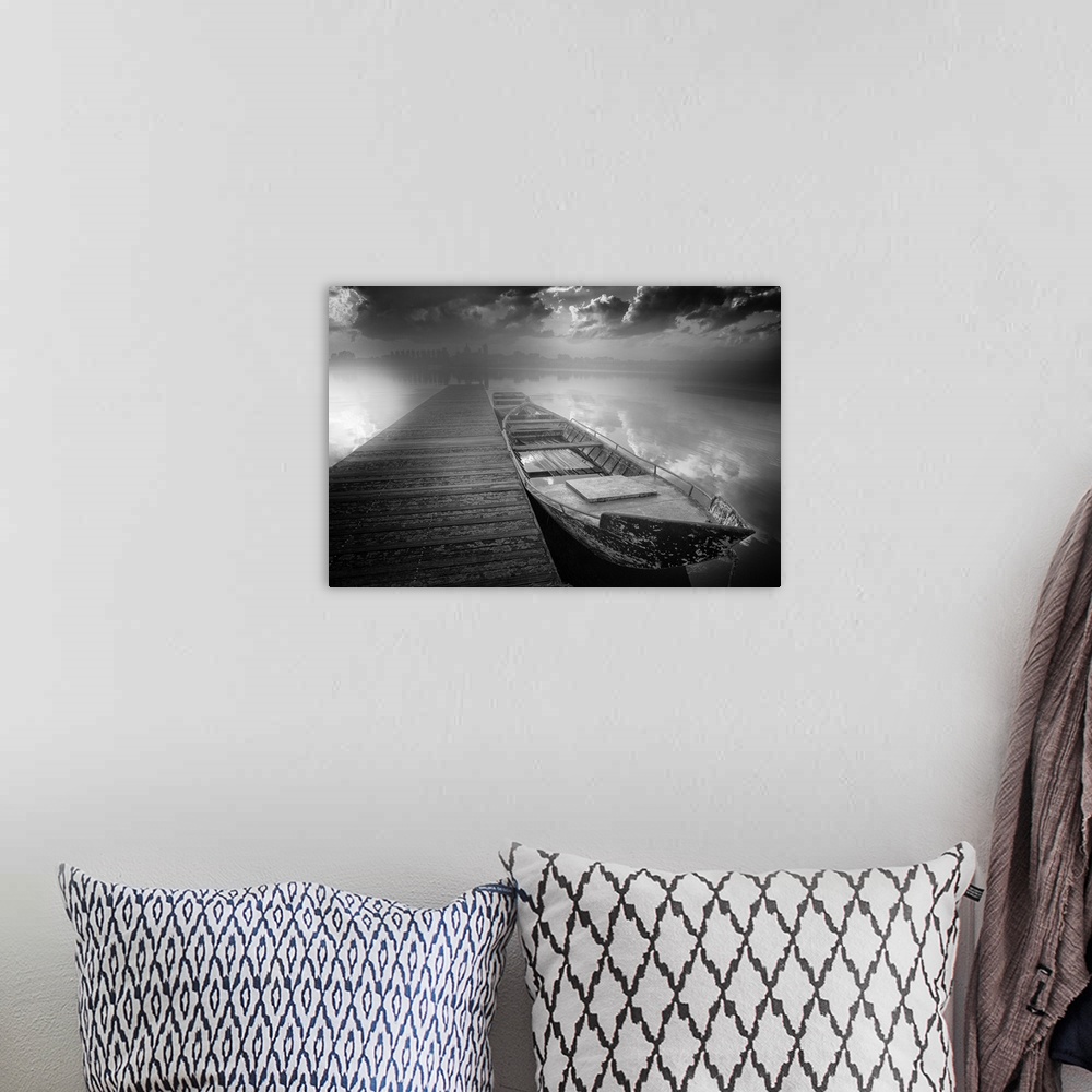 A bohemian room featuring Black and white photograph of boats docked on a harbor with contrasting clouds and a city skyline...