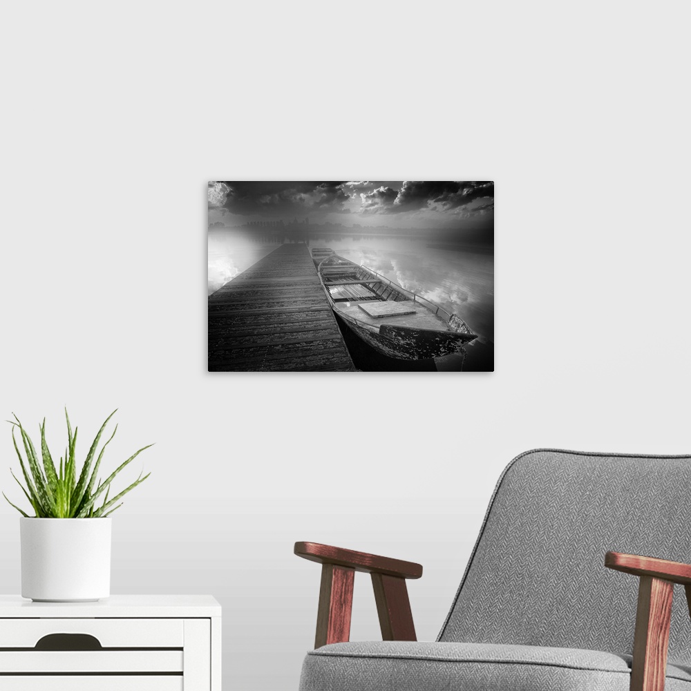 A modern room featuring Black and white photograph of boats docked on a harbor with contrasting clouds and a city skyline...