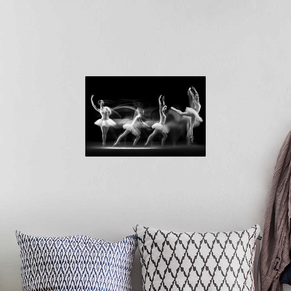 A bohemian room featuring Long exposure photo of a ballerina dancing across the stage, showing four different poses.