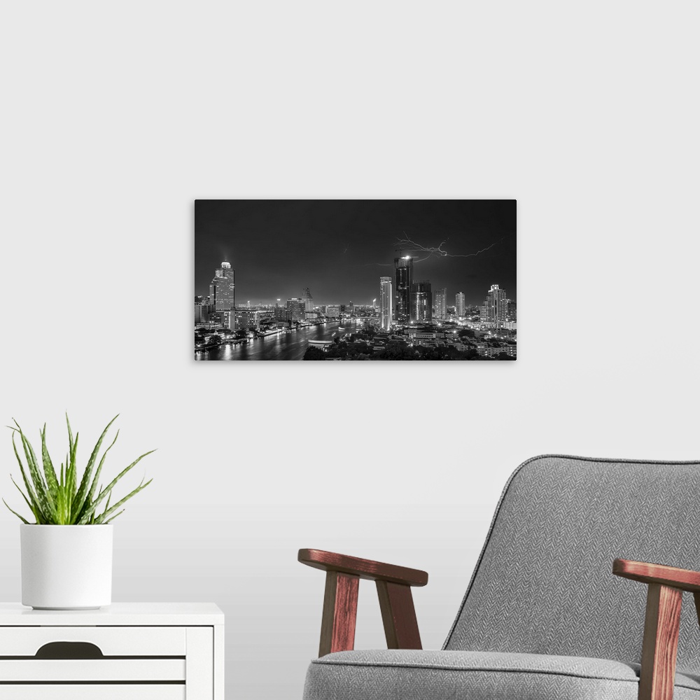 A modern room featuring An aerial photograph of the Bangkok skyline with lightning overhead.